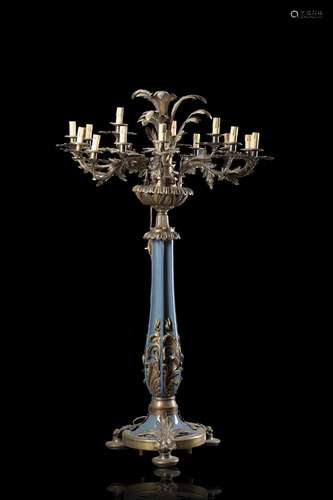 A cast iron and bronze eighteen-light candle holder decorate...