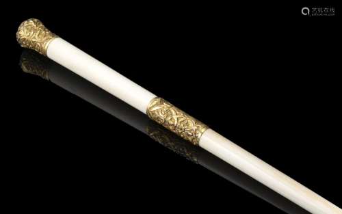 An ivory baton with gold inserts, inscription reading "...