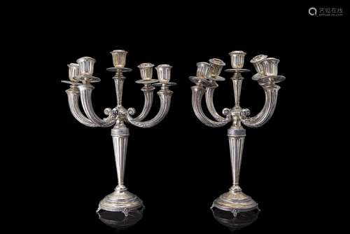 Two five-light silver candle holders decorated with plant mo...