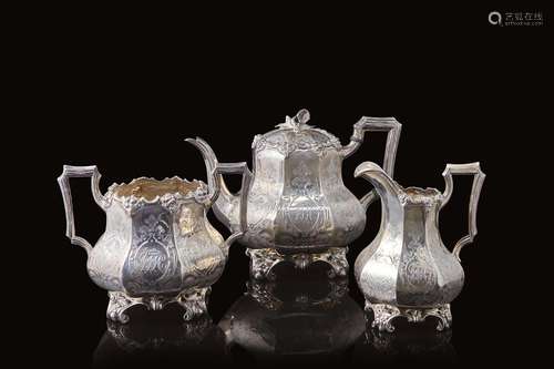 An engraved silver tea set comprising a teapot, a milk jug a...