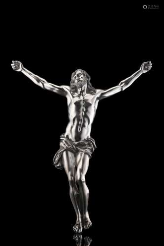 A silver sculpture representing crucified Christ. Titled 800...