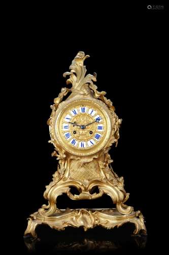 Ormolu mantel clock decorated with rocaille patterns. Ourmol...