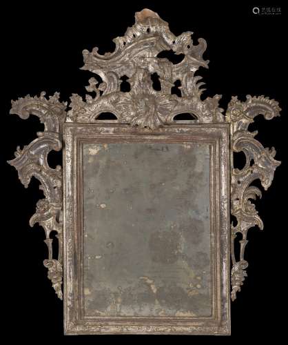 An 18th-century carved silvered wooden mirror (cm 132x110) (...