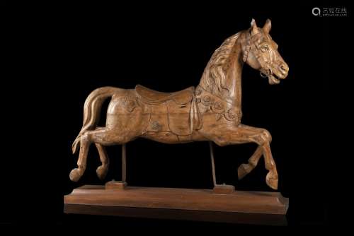 19th-century art. A wooden sculpture of a horse on a later r...