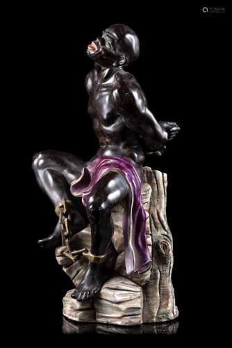 Polychrome porcelain figure depicting dark slave with drape,...