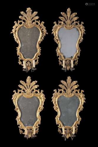 A lot comprising four 18th-century giltwood mirrors carved w...
