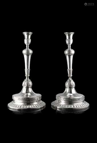 A pair of late 18th-century silver candelabras on a chiselle...