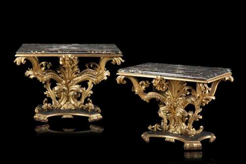 A pair of antique giltwood consoles carved with flowers and ...