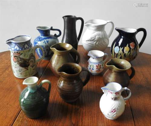 A COLLECTION OF ELEVEN CERAMIC AND POTTERY JUGS, including a...