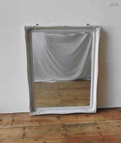 A CONTEMPORARY CREAM FRAMED OVERMANTEL AND WALL MIRROR, both...