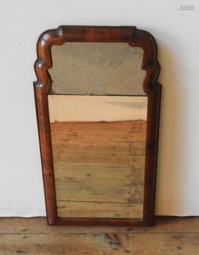 AN 18TH CENTURY WALNUT FRAMED CONTINENTAL WALL MIRROR, the w...