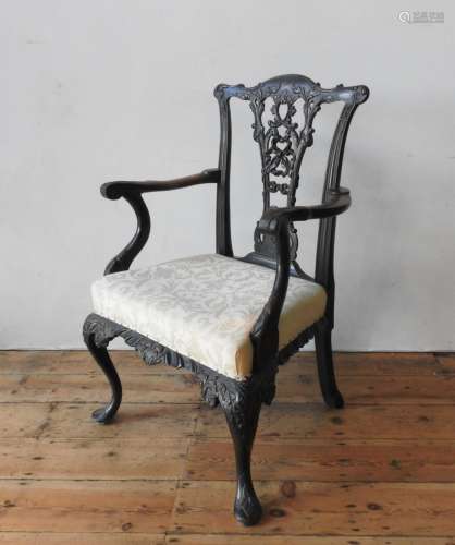 A 19TH CENTURY ORNATE CARVED MAHOGANY ELBOW CHAIR, with an p...