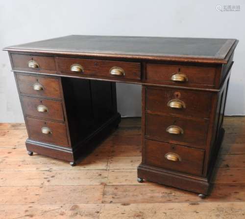 AN OAK 1930'S TWIN PEDESTAL WRITING DESK, with two banks of ...