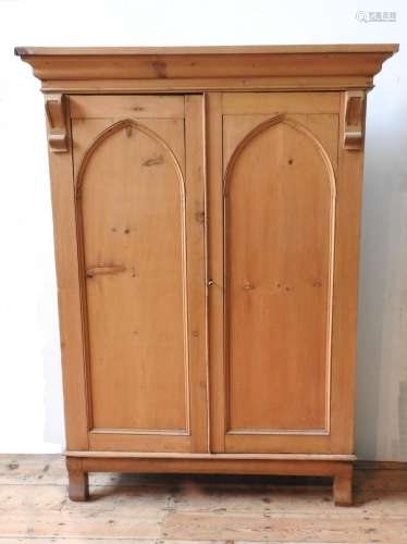 A 19TH CENTURY WAXED PINE ARCH PANELLED CUPBOARD, with corni...