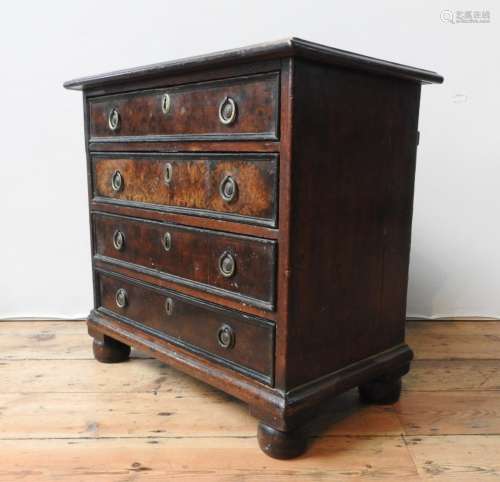 A 19TH CENTURY MAHOGANY AND WALNUT CHEST OF FOUR DRAWERS ON ...