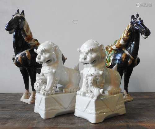 A PAIR OF BLANC DE CHINE LION FIGURES AND TWO TANG-STYLE HOR...
