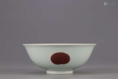 AN UNDRGLAZED RED BOWL WITH FLOWER AND FRUIT PATTERNS