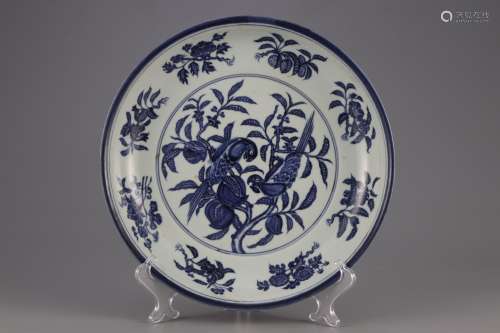 A BLUE AND WHITE PLATE PAINTED WITH FLOWERS AND BIRDS