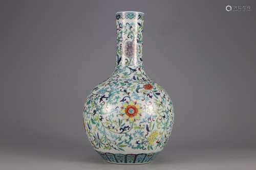 AN OVERGLAZED VASE PAINTED WITH FLOWERS