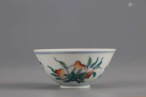 A BLUE-AND-WHITE AND OVERGLAZED CUP PAINTED WITH FLOWERS AND...