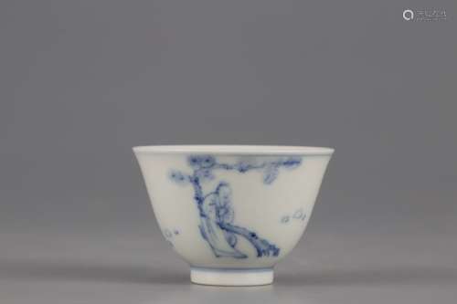 A BLUE AND WHITE CUP PAINTED WITH CHARACTER
