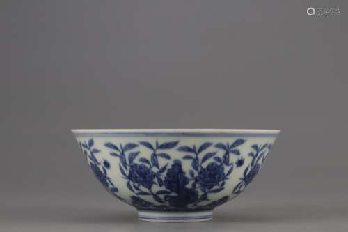 A BLUE AND WHITE BOWL PAINTED WITH FLOWERS