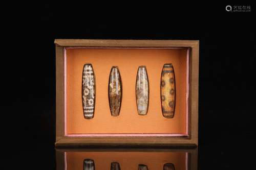 A Set Of Four Dzi Beads With Box