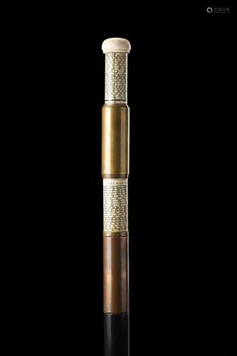 An ebonized wood walking stick with copper and brass handle ...