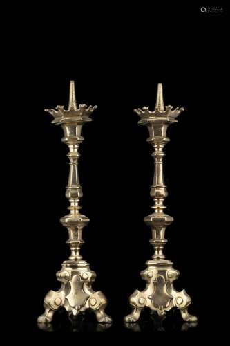 Two 18th-century bronze candle holders (h. cm 53) (minor def...
