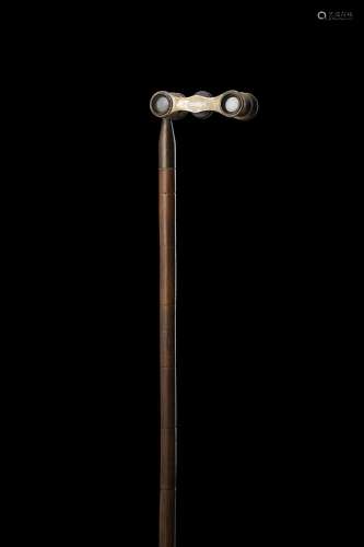 A mahogany walking stick with brass binoculars handle marked...