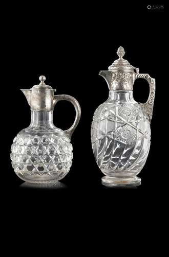 A lot comprising two crystal bottles with silver handles. En...