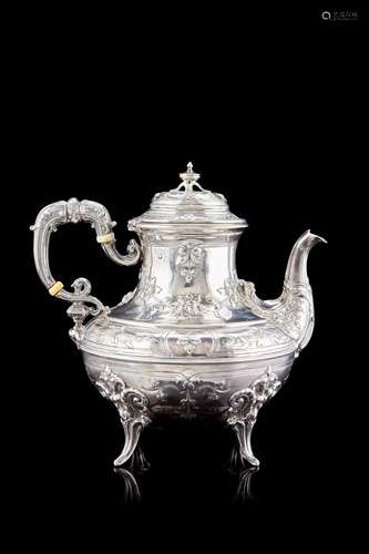 An embossed silver teapot engraved with flower garlands. Fra...