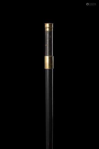 An ebonised wood walking stick hiding a telescope in the kno...