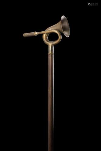 A wooden walking stick with brass handle for fox hunting ins...