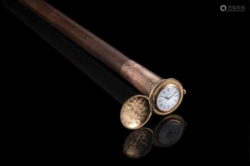 A malacca walking stick with gilded metal handle enclosing a...