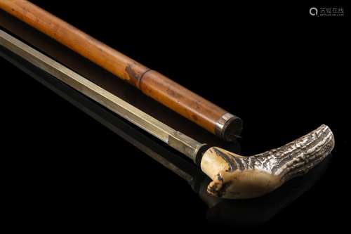 A bamboo walking stick with deer horn enclosing a brass and ...