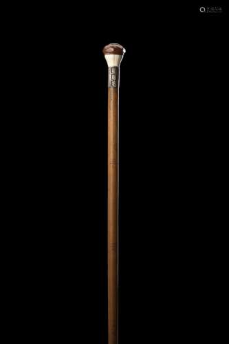 A malacca walking stick with a wood and ivory knob with two ...