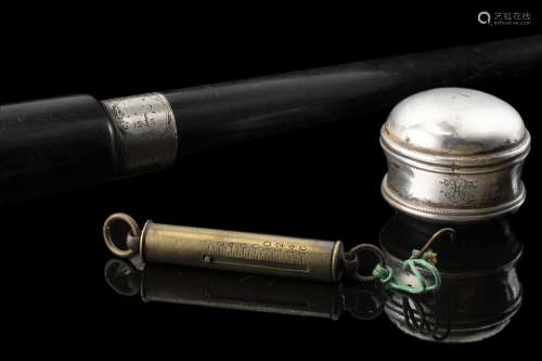 An ebonized wooden walking stick with a silver knob ciphered...