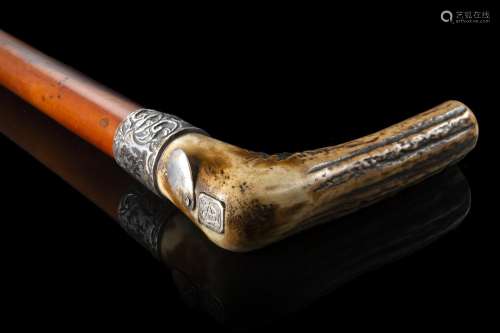 A 19th-century malacca walking stick with horn handle enclos...