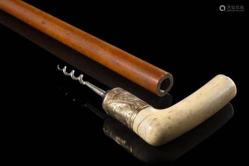 A malacca walking stick with ivory handle enclosing a corksc...