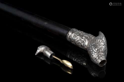 An ebony walking stick with silver quail shaped handle enclo...