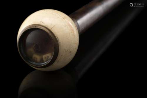 A 19th-century wooden gaming walking stick with an ivory kno...
