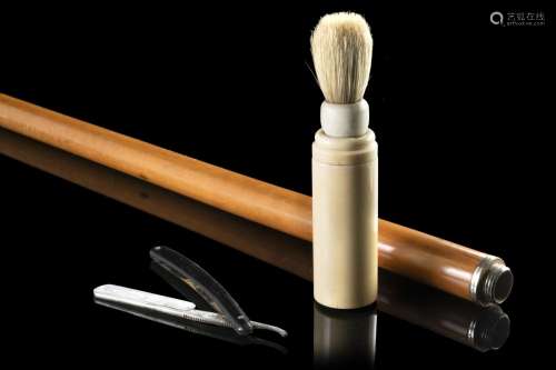 A malacca toilette stick hiding a shaving set in the ivory h...