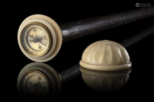 An ebonized wood walking stick with a detachable ivory knob ...