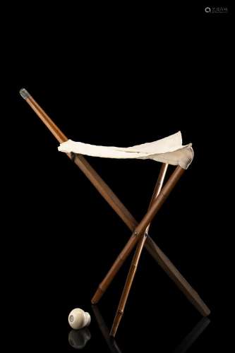 A bamboo walking stick with an ivory handle enclosing a comp...