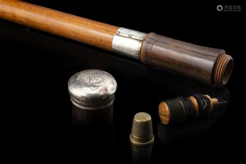 A malacca tailor walking stick hiding a thimble, a needle an...