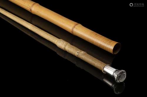 A bamboo walking stick with a silver plated knob hiding a ri...