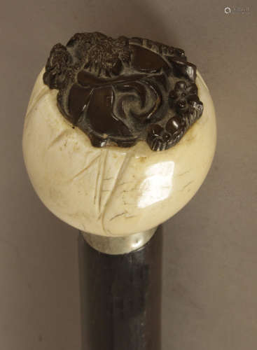 A 19th century Oriental walking stick with a carved ivory ha...