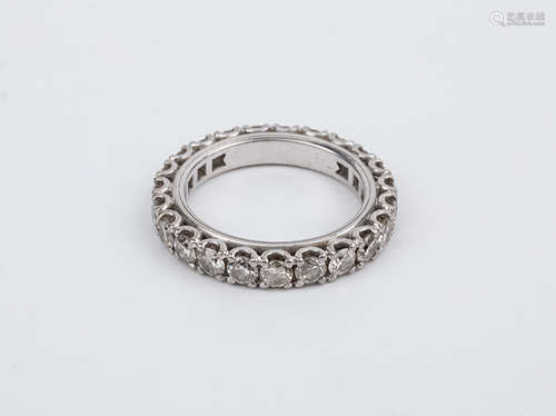 An 18k. white gold and brilliant cut diamonds eternity ring