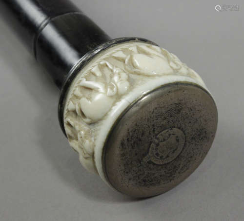 A 19th century walking stick with a carved ivory handle and ...